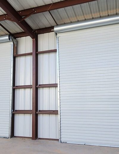 Two large roll-up doors are prominently featured on the exterior of a building, showcasing a functional design.