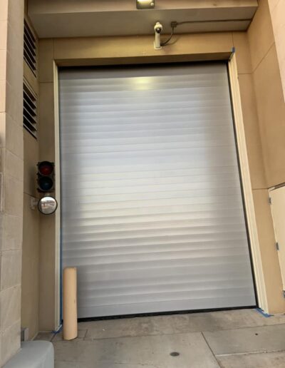 A large garage door featuring a prominent window, allowing natural light to illuminate the interior space.