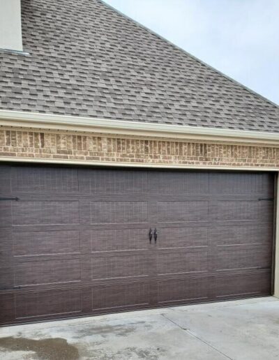 A garage door featuring a rich brown finish, showcasing a sleek and modern design.