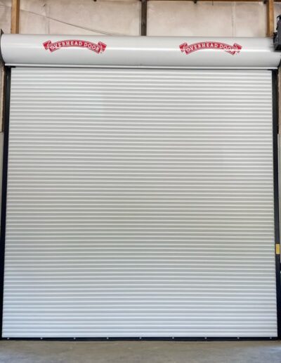 A large white roller door featuring bold red lettering prominently displayed on its surface.