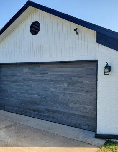 A garage door featuring a stylish black and white trim, enhancing the overall aesthetic of the exterior.