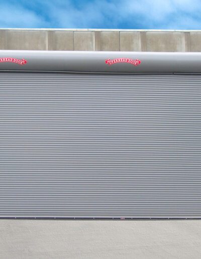 A large roller door featuring a prominent red stripe across its surface.